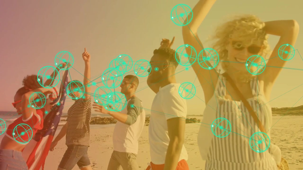Five adults walking sandy shore, man waving US flag and activating teal network overlay marketing