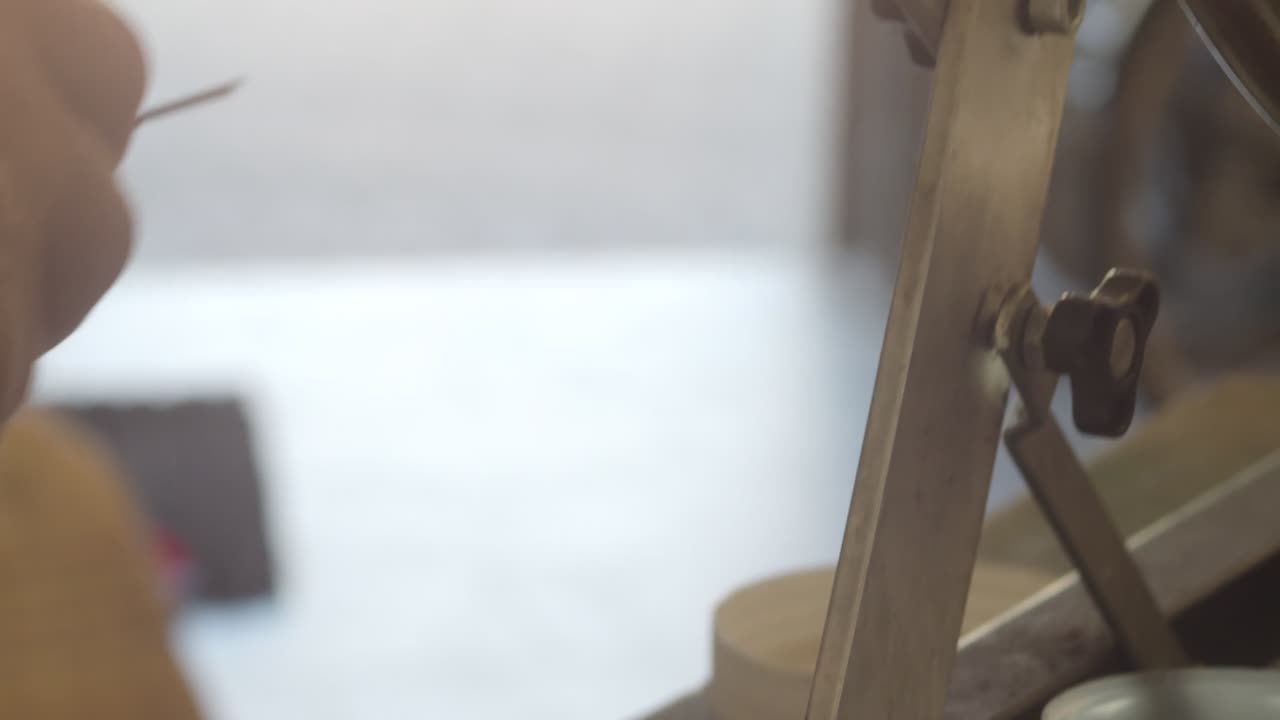 Metal component receiving precise cleaning, technician carefully brushing surface with wire tool for maintenance and optimal performance, extreme close up, real time