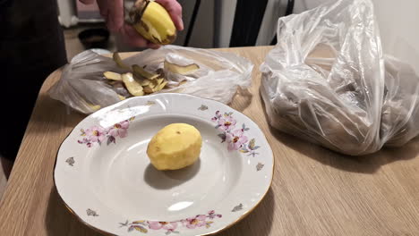 Fast-motion-shot-of-male-hands-peels-raw-fresh-potatoes-and-placing-them-in-a-white-plate