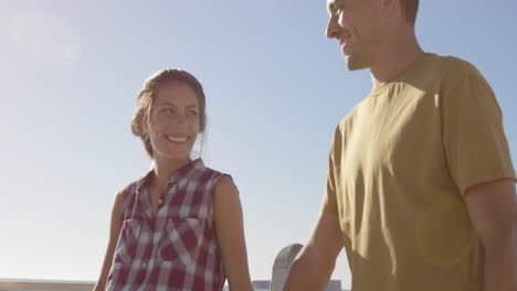 Young-adult-couple-relaxing-at-the-seaside