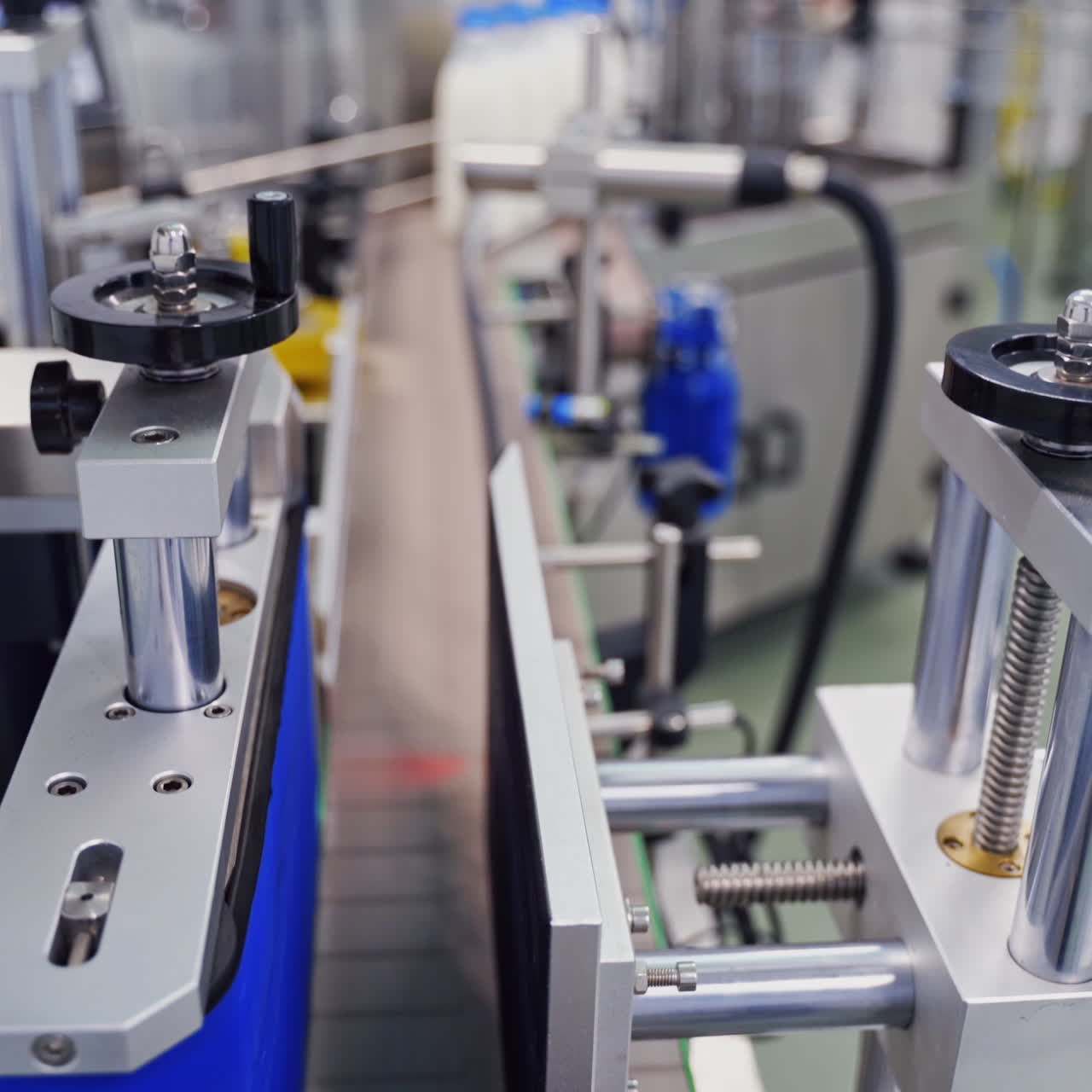 Modern equipment on a dairy factory. Automatic production line with milk bottles in upgraded dairy plant.