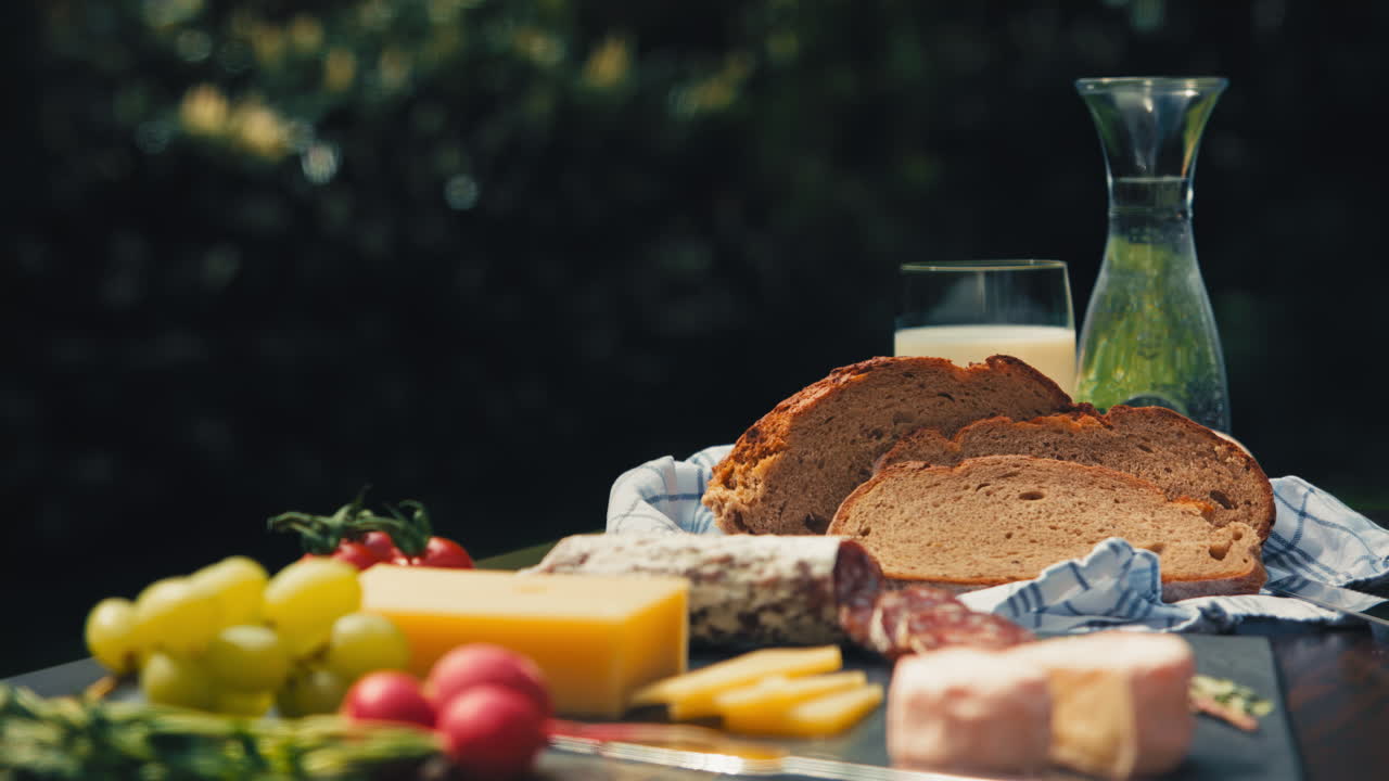 Indulge in a picnic paradise with a delightful assortment of snacks on an inviting garden table. A feast for the senses.  Great for food vlogs, recipe videos, and appetizing product presentations