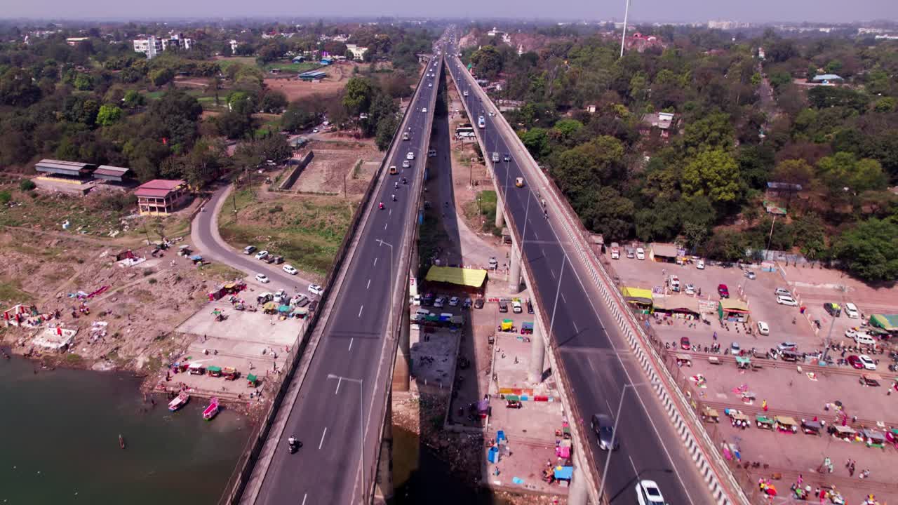 Tilwara Bridge with Narmada River and trees at Narmada Ghat, tilwara, jabalpur, madhya pradesh, india. day time, tilt up, drone shot, 4k.