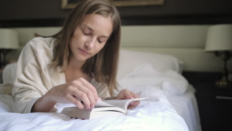 woman reading a book in bed