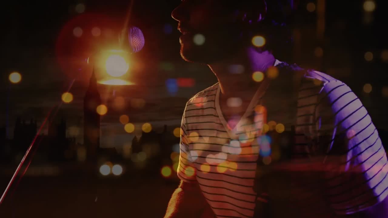 Animation on blurred night road traffic over midsection of caucasian man playing guitar