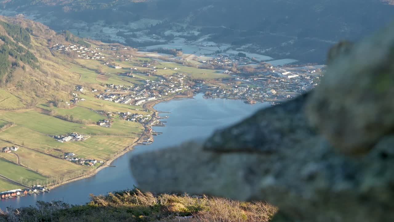 Olen village revealed from behind mountain rocks at Katanuten in Vindafjord, Norway during sunset