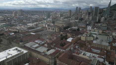 drone-approaching-Bogota-capital-city-main-square-historical-center-aerial-view-of-Colombia-capital-with-andes-mountains-landscape