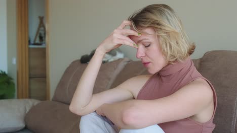 a woman experiencing sadness and anxiety at home