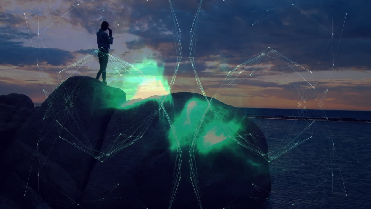 Woman standing on rocky shore at sunset, with technology network lines and drifting data clouds