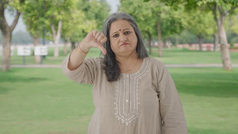 Disappointed-Indian-old-woman-showing-thumbs-down-in-park