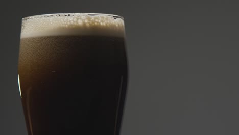 cerca de una pinta de cerveza negra irlandesa en vidrio para celebrar el día 21 de san patricio