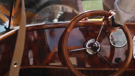 turning a wooden steering wheel on a boat