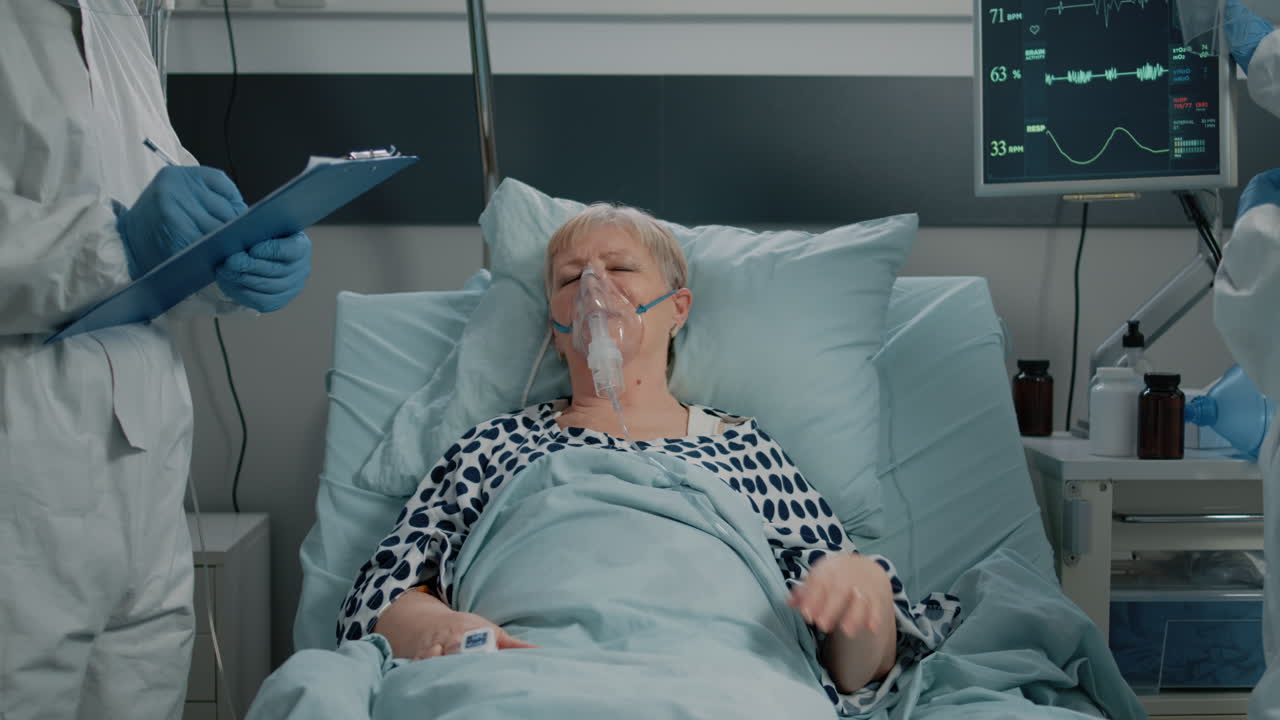 Paramedics consulting heavy breathing woman with oxygen tube