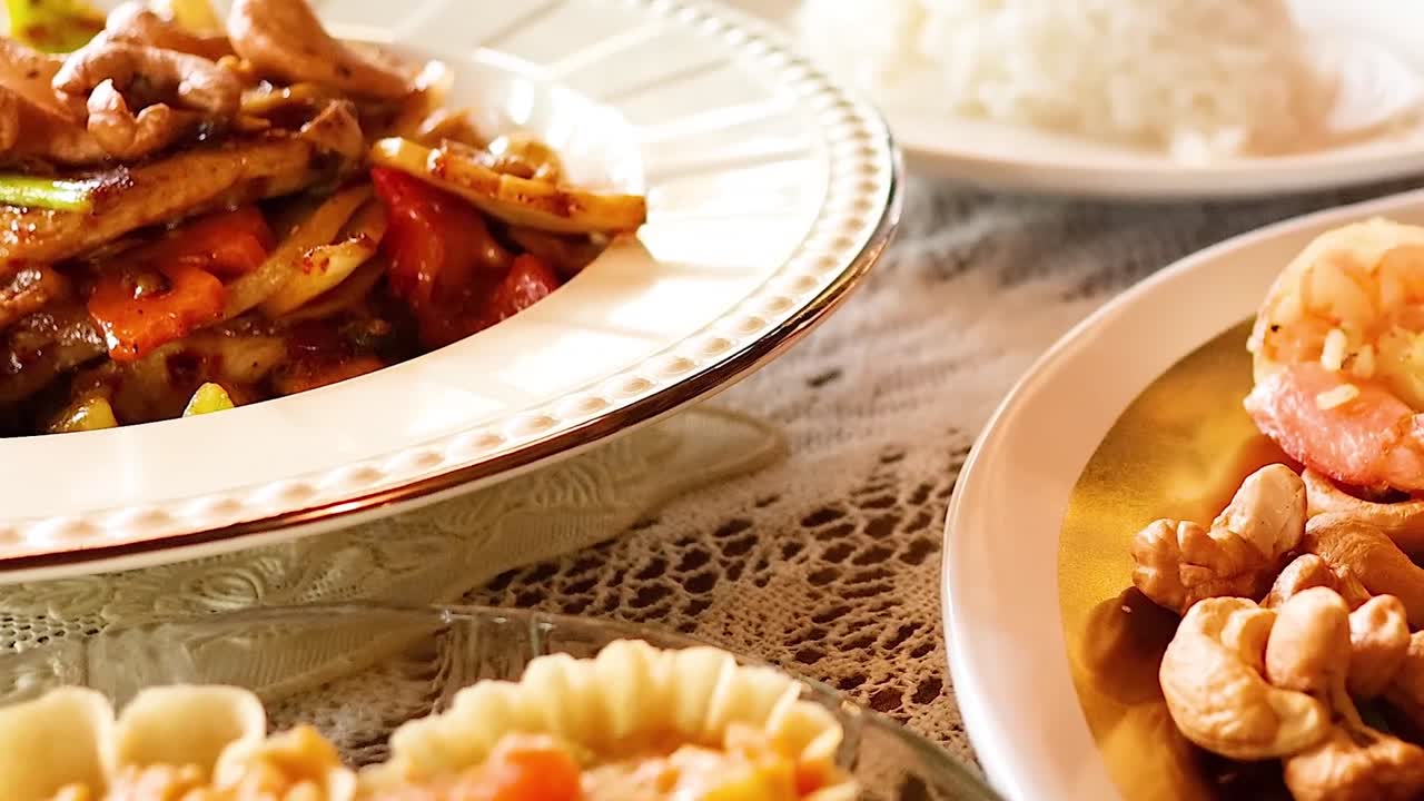 A close-up view of Thai dishes featuring fried rice, shrimp, cashews, and vibrant garnishes on elegant plates.