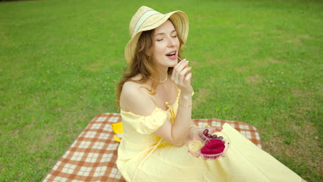 woman eating fruit on picnic