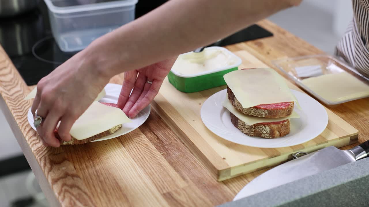 Making sandwiches with cheese and salami
