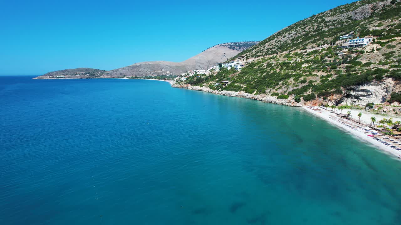 Hidden Ionian Beach with Crystal Blue Water and Tourists Sunbathing on Summer Holiday in Albania