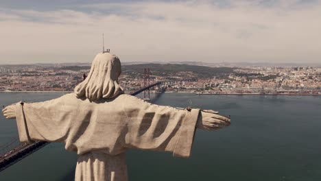 panoramic panning shot, sacred statue of christ the king looking at lisbon, capital city of portugal