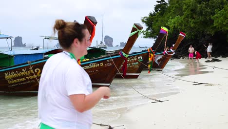 relaxing beach scene with longtail boats in thailand