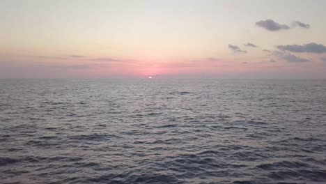 a beautiful clip of pink and gray hues over the sun rising over the mediterranean sea just off the jaffa harbor in israel