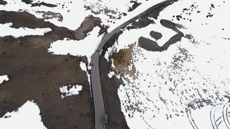 aerial-top-down-car-driving-in-world's-highest-village-hikkim-in-spiti-valley-in-himachal-pradesh-India-winter-snow-landscape