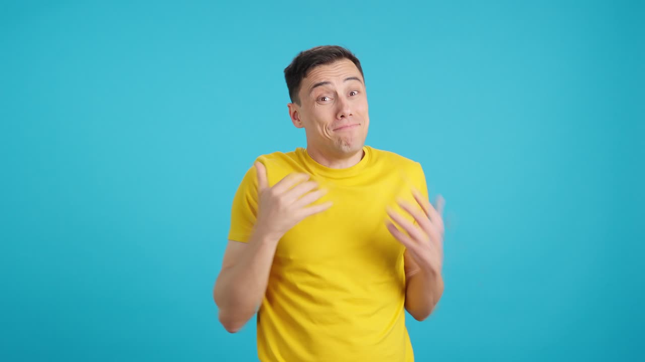 Man in yellow shirt making call me gesture