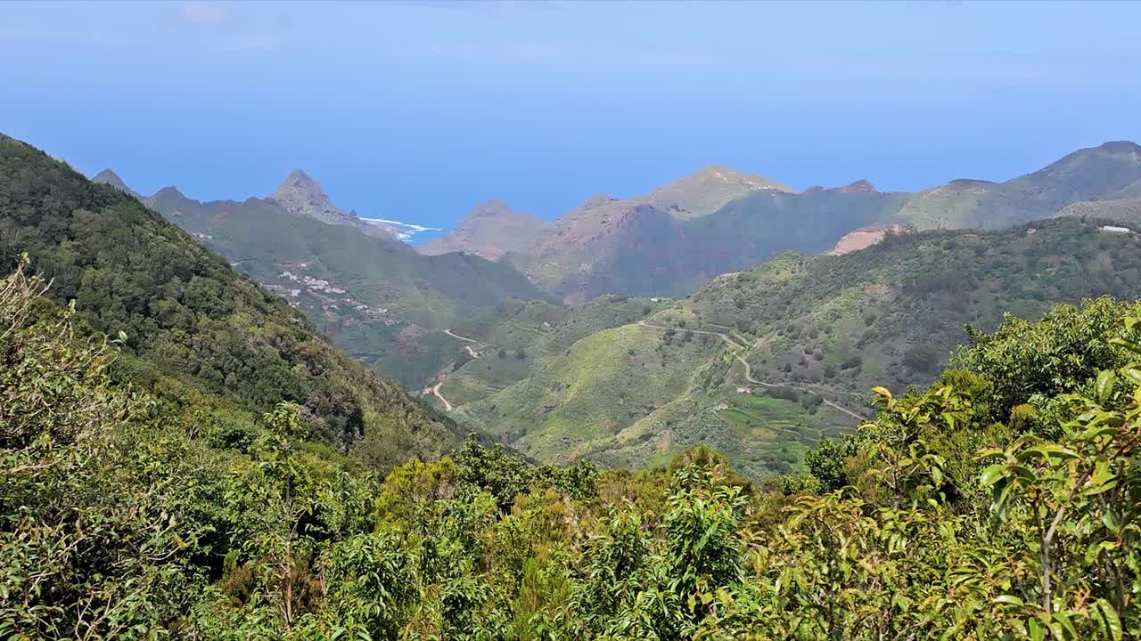 Mountainous view of Anaga, Spain, showing lush greenery and a coastal backdrop