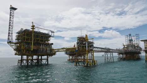 low-angle dolly shot of big offshore petrochemical processing platform, oil and gas industry