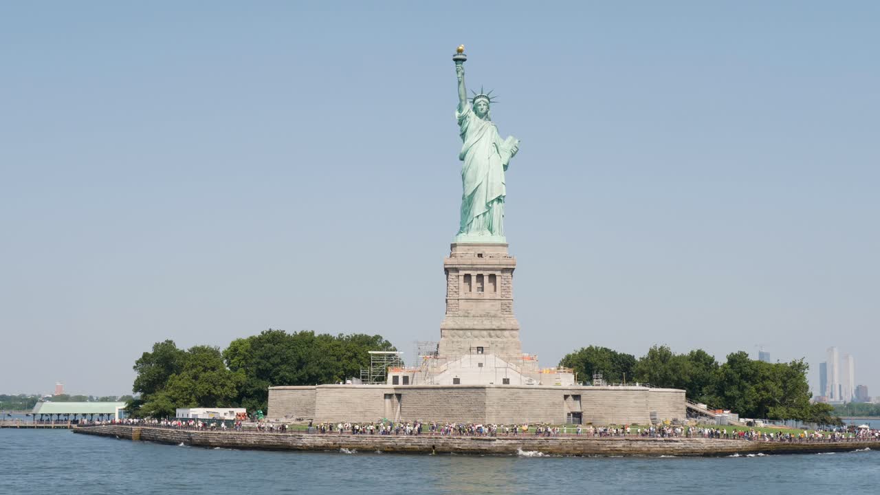 Slow motion view of people at Statue of Liberty icon monument sculpture in New York City Manhattan Staten Island USA America travel tourism Hudson River Harbour