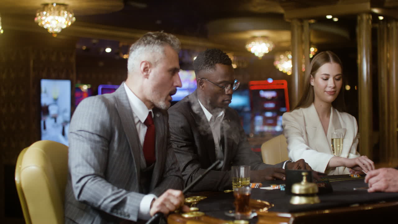 Poker players smoking and drinking in the casino.
