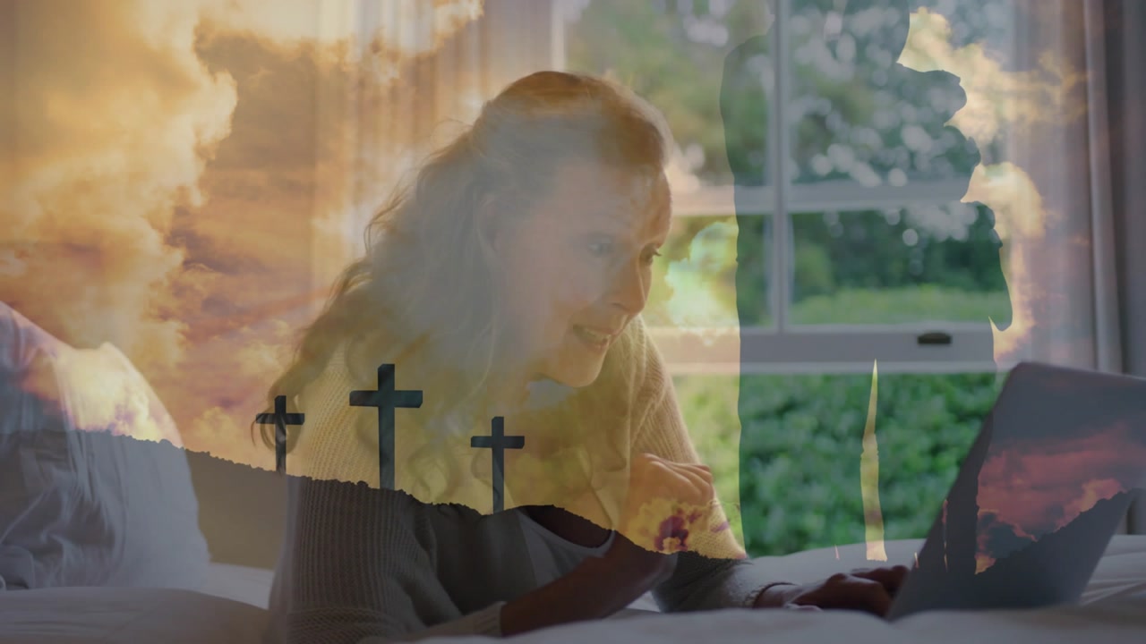 Woman on bed looking at laptop, typing and gesturing while faint 3-cross overlay shifting for faith