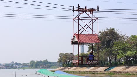 cable car moves across river with passengers aboard.