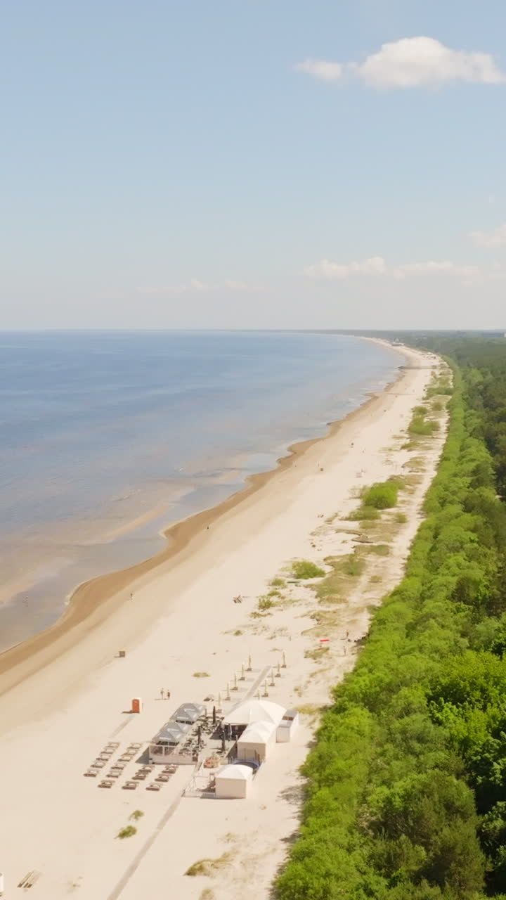 Aerial portrait circling along the Jurmala beach, sunny, summer day in Latvia