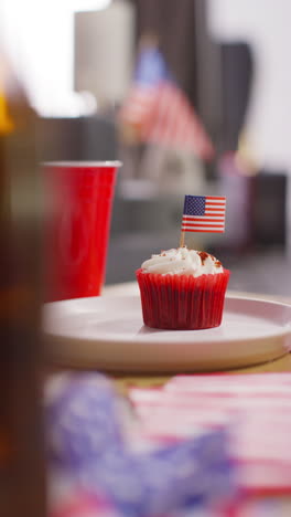 Vertical-Video-Close-Up-Of-Cupcakes-With-American-Stars-And-Stripes-Flags-And-Bottles-Of-Beer-At-Party-Celebrating-4th-July-Independence-Day