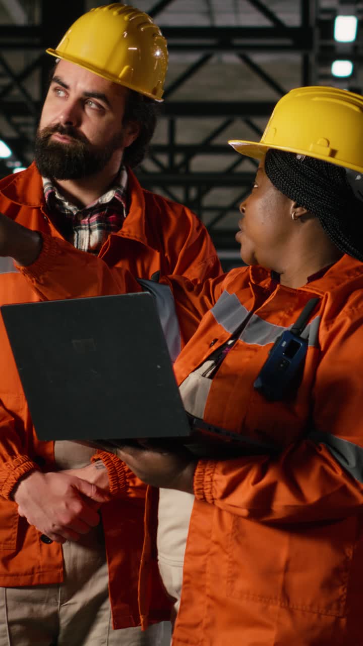 Vertical Video Diverse engineers, using walkie-talkie, portable transceiver, heavy industry