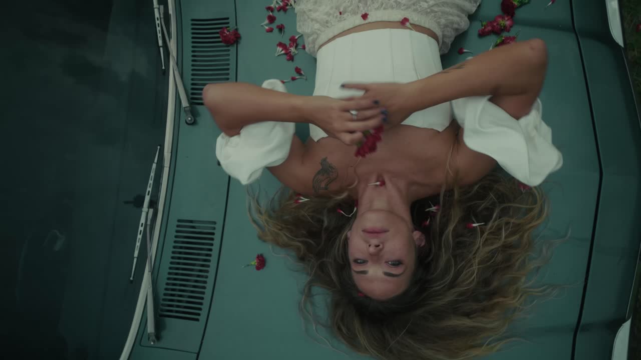 Woman Laying on Vintage Car with Flowers