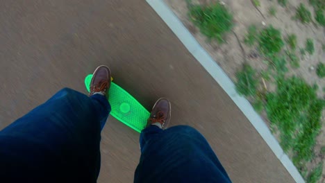 adult man rides on a small children's skateboard