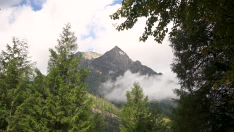 clouds in front of mount vaught in glacier national park during the day, time lapse