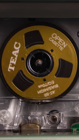 teac audio cassette tape reel spinning during playback or recording, macro close up