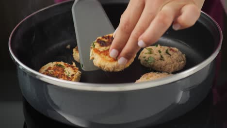 Cooking-crab-cakes,-removing-deliciously-seared-patties-from-the-hot-pan