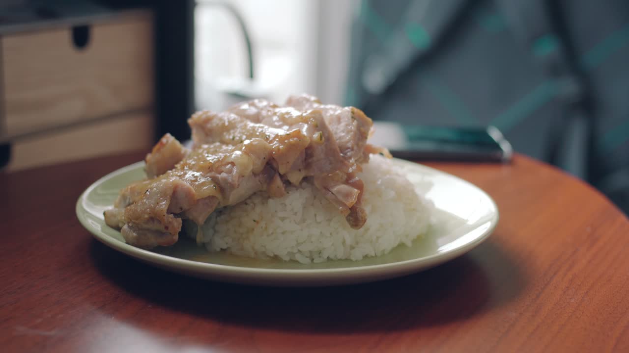 Pouring Sauce Over A Plate Of Chicken Fillet And White Rice. - close up shot