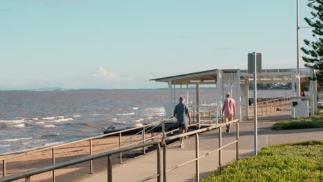 australian beach with people walking and trees