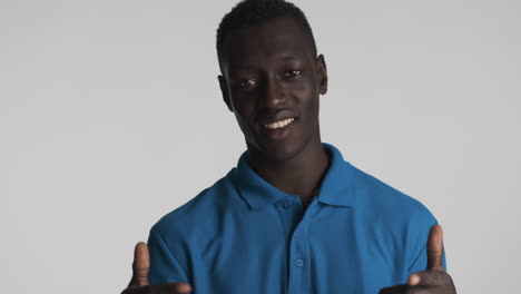 happy african american man on grey background.