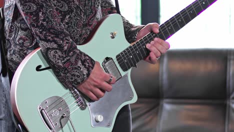 lonely player playing guitar in his studio