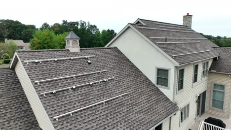 metal tracks installed on shingle roof of usa house prepped for solar panel installation