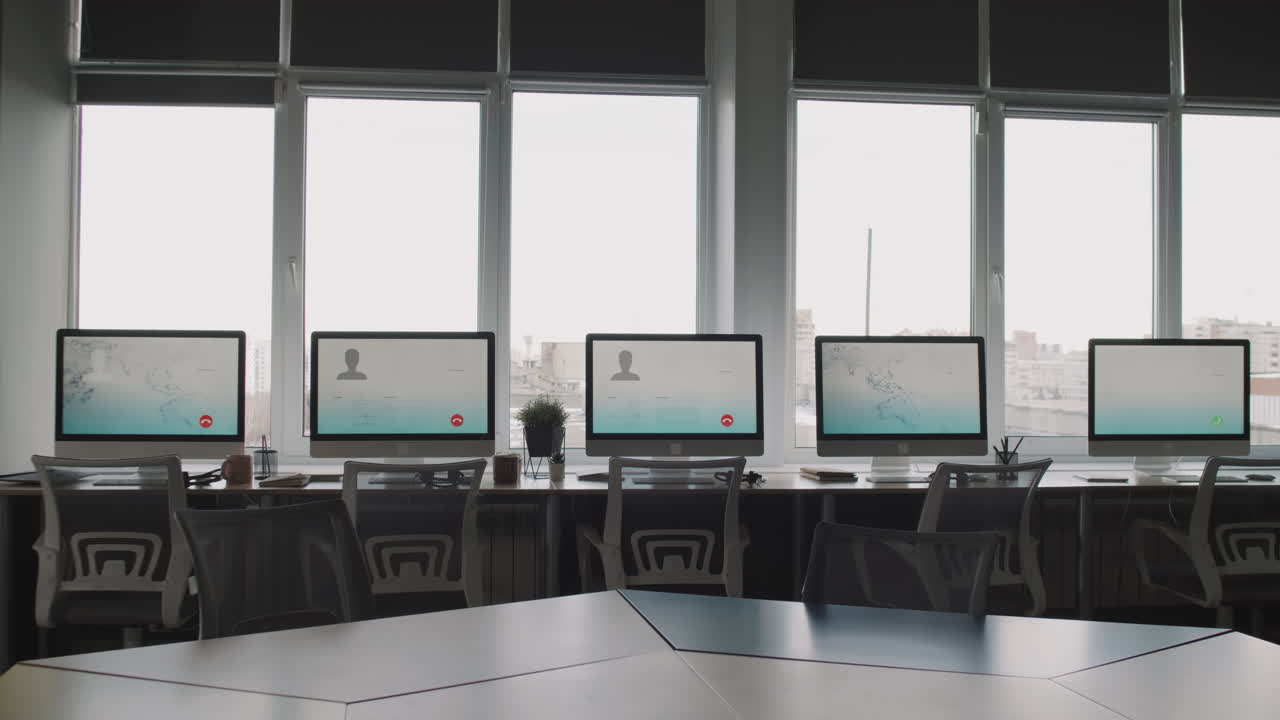 Modern Office Workspace with Computers and Windows