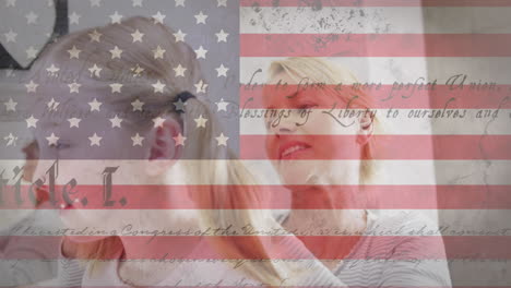 american flag and constitution text against caucasian mother brushing hair of her daughter at home