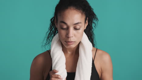 african american tired woman over blue background.