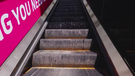 going up an escalator in shopping mall