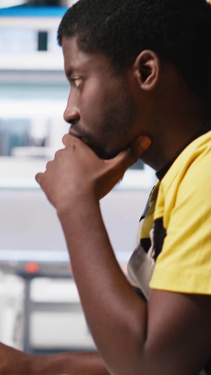 Vertical Video Black engineer works on solar software settings in automated factory